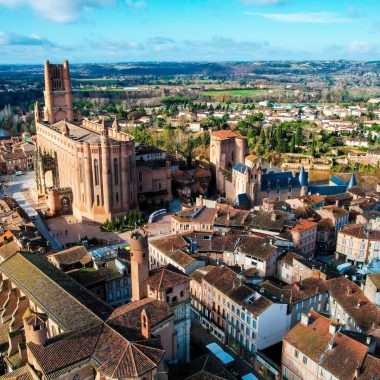 Fly over Albi and the perimeter listed as World Heritage: above the roofs the cathedral, the Saint-Salvi collegiate church, the BErbie palace, the covered market hall